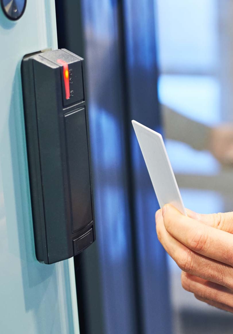 Electronic key and access system. Male hand with card using card for access in office